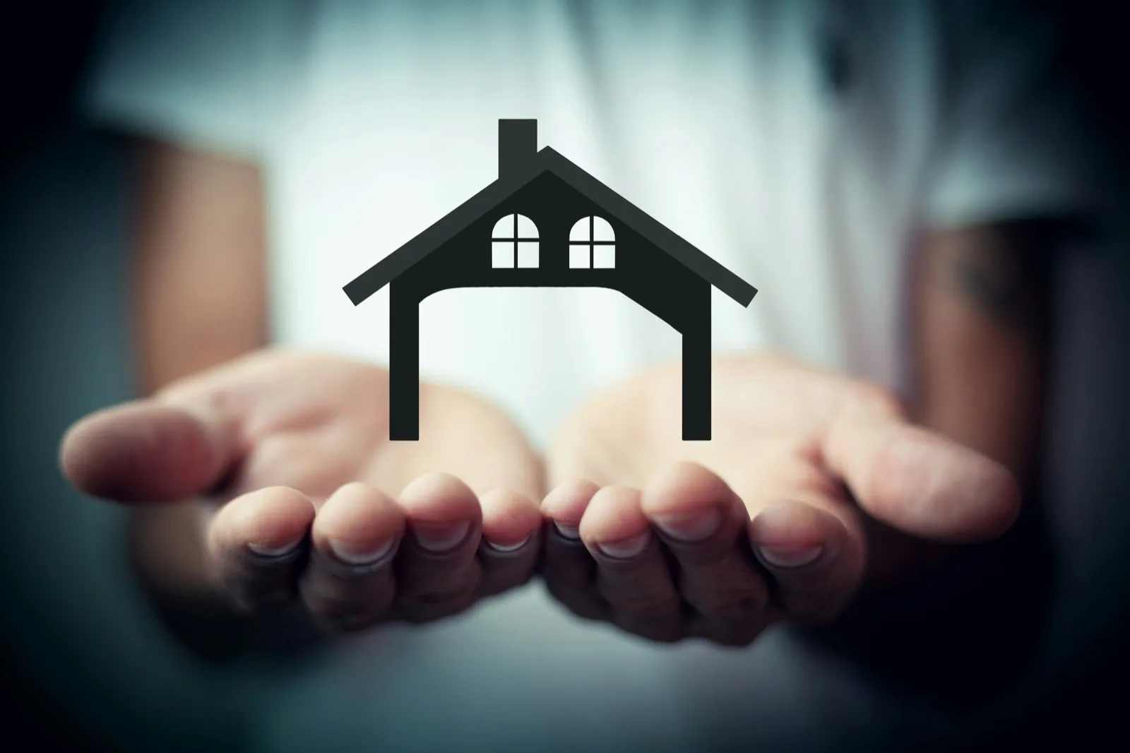 Hands cradling a house icon, representing careful property management